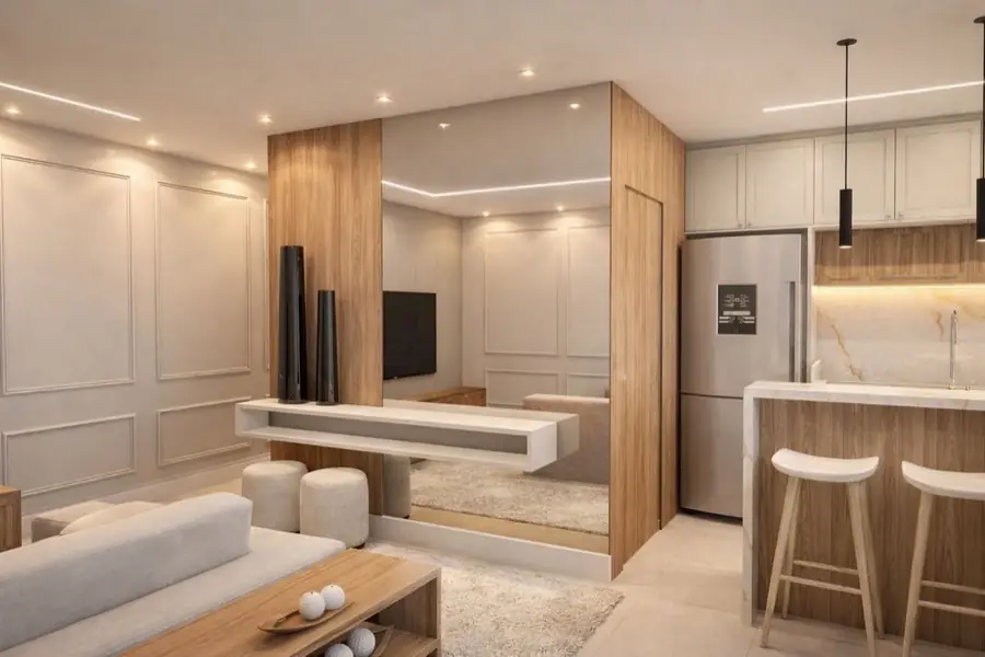 Sala de estar integrada à cozinha, com espelho emoldurado em madeira e ilha em mármore branco.